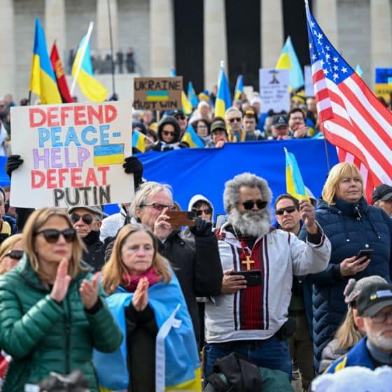 Rally in Washington in support to Ukraine, people wear vyshyvanka, national dress of Ukrainian people and carry flags: Ukrainian and American, as well as Defend Peace demand